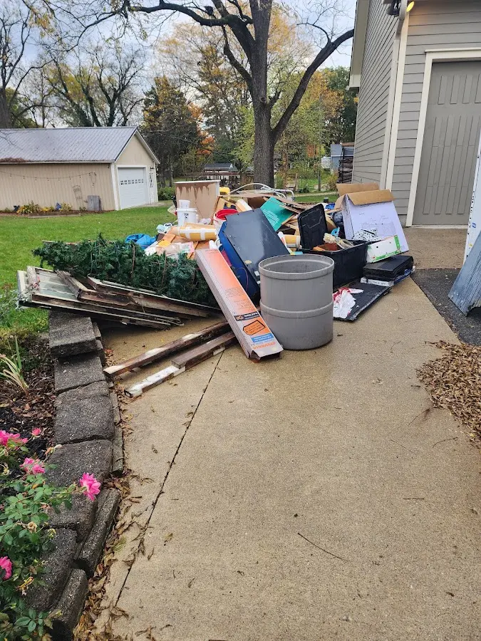 Dumpster being loaded with debris for Residential Dumpster Rental in Pinehurst